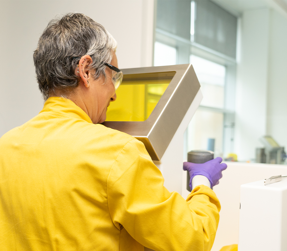An image of a scientist working on radiopharmaceutical research in a laboratory