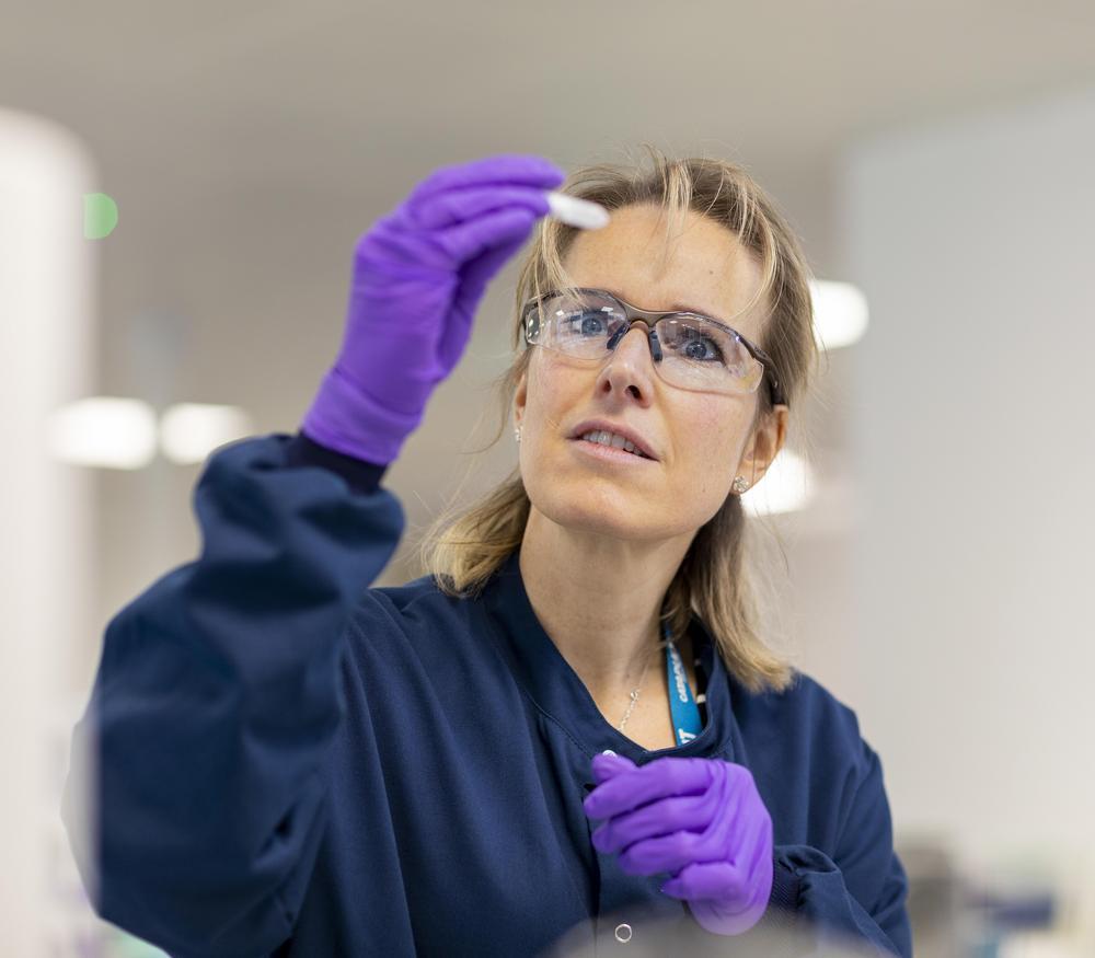 A scientist looking at a test tube in a laboratory.