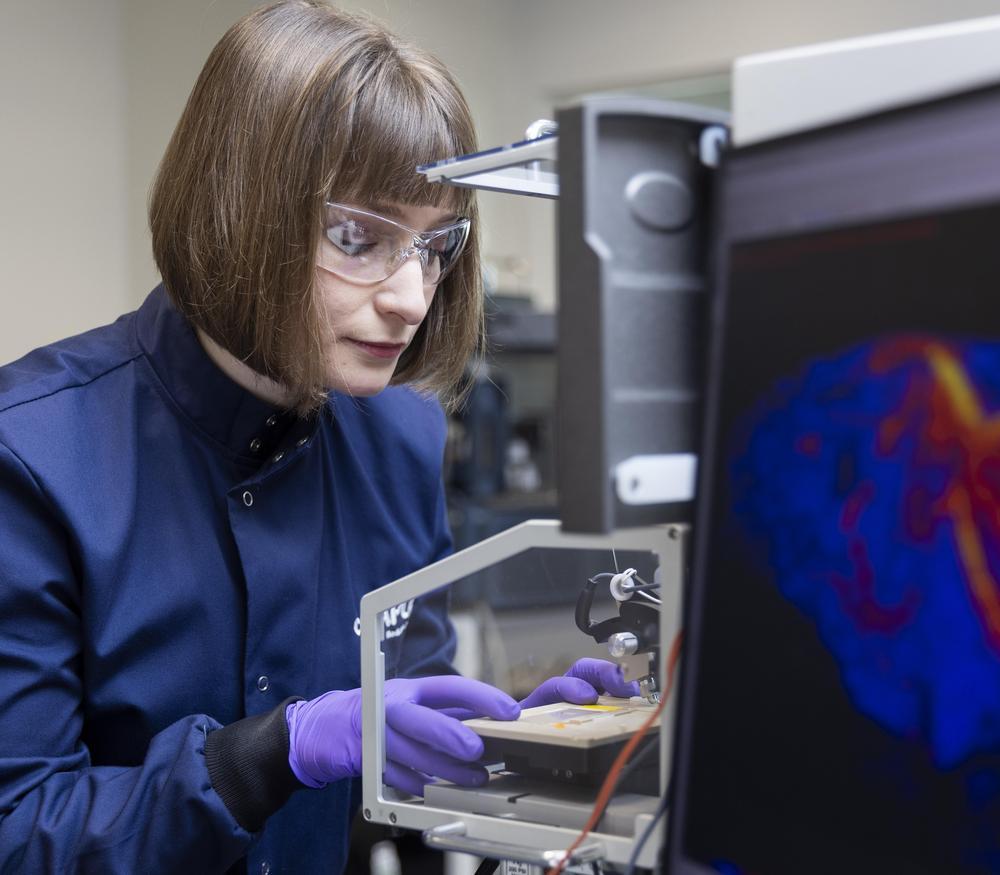 Scientist places a sample on the source of a DESI mass spectrometer