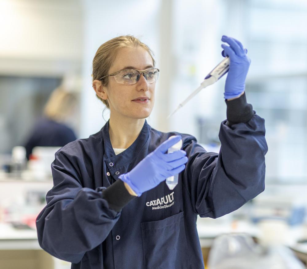 female scientist using a pipette in a lab