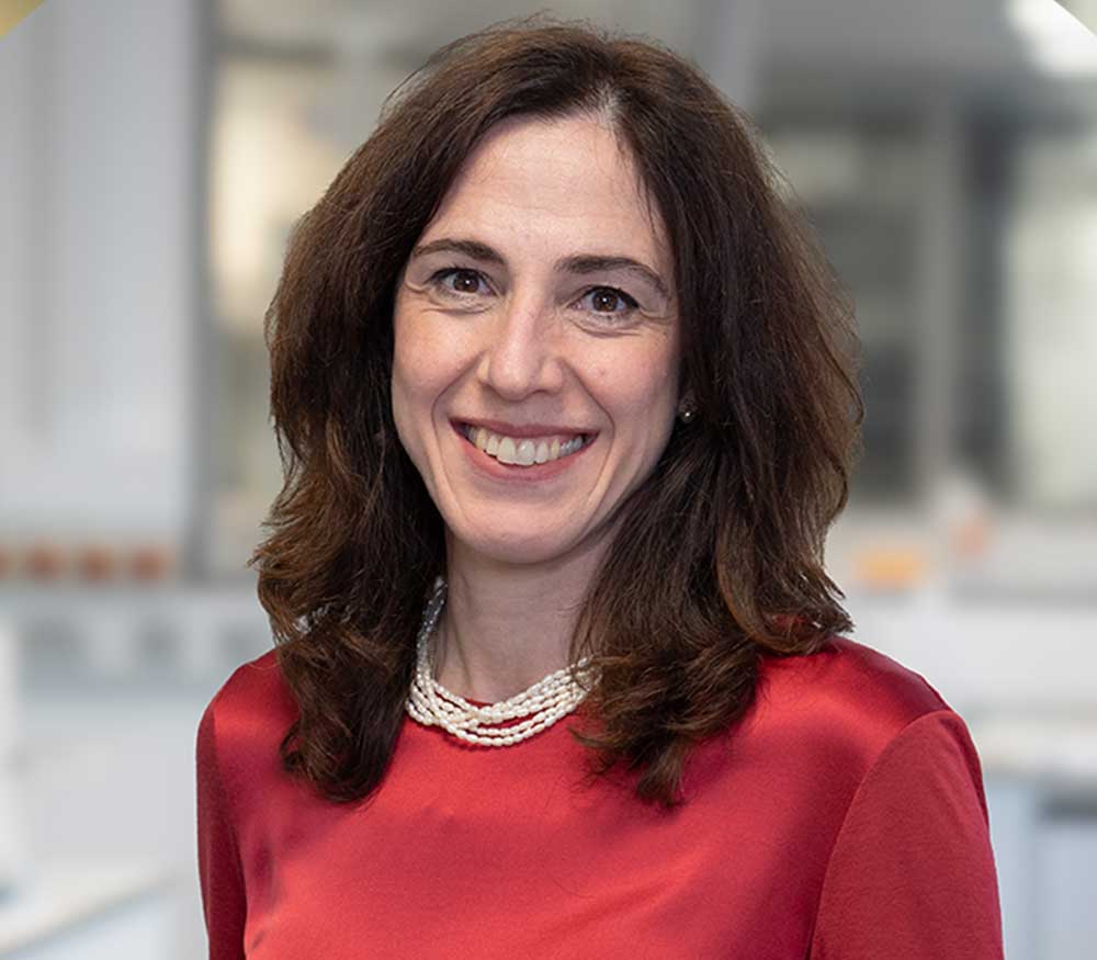 A photo of Sara Imarisio, a neuroscientist in a laboratory at Medicines Discovery Catapult