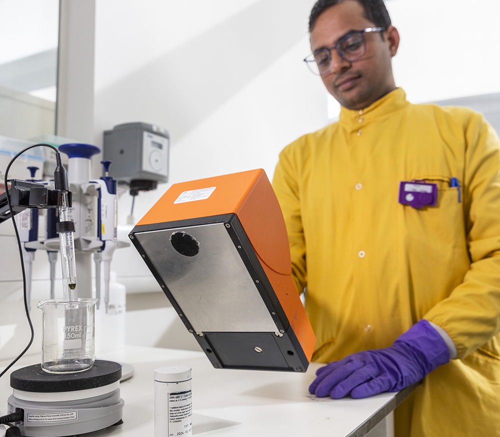 A radiochemistry scientist operates a Geiger counter in a laboratory